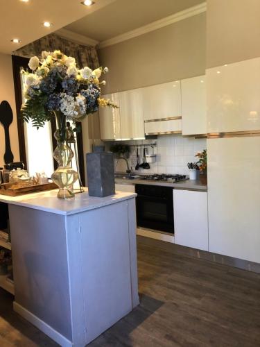 a kitchen with a vase of flowers on a counter at Il Pioppo Antico in Viggiù