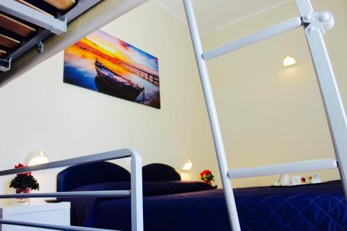 a bedroom with a bunk bed and a painting on the wall at Hotel Fedora Rimini in Rimini