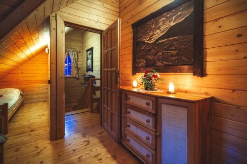 a room in a cabin with candles on a dresser at Leśna Bacówka in Nowy Targ