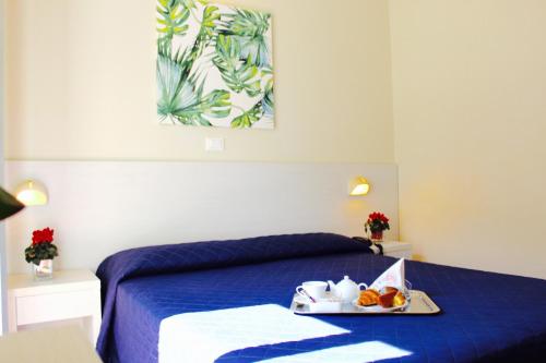 Кровать или кровати в номере Hotel Fedora Rimini