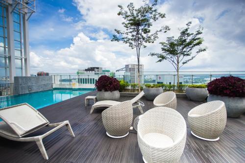 a balcony with chairs and a pool on a building at Suasana suites By The one in Johor Bahru