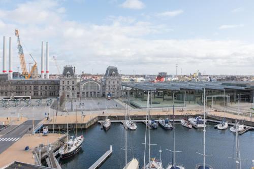 a group of boats docked in a marina in a city at Whaaw Oostende in Ostend