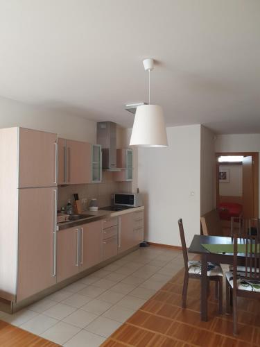 a kitchen with a table and a dining room at Apartament HEL in Hel