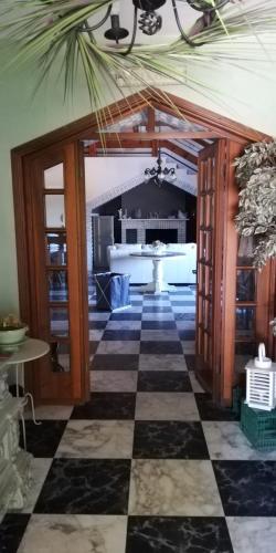 a living room with a checkerboard floor and a kitchen at La Gallina Nel Castello in Albenga