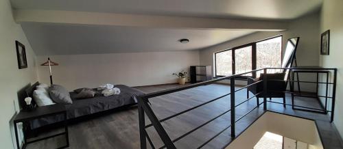 a living room with a bed and a staircase at Lux GUEST HOUSЕ МUKACHEVO in Mukacheve
