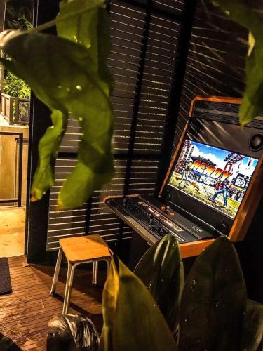 a room with a table with a video game on the screen at Exclusive access to the whole garden. in Bangkok