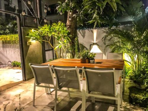 a table and chairs in a room with plants at Exclusive access to the whole garden. in Bangkok
