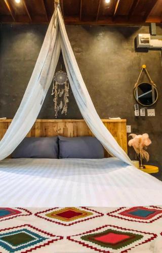 a bedroom with a bed with a mosquito net at Exclusive access to the whole garden. in Bangkok