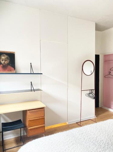 a bedroom with a desk and a wall of white cabinets at B&B Expo House in Antwerp
