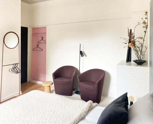 a bedroom with two chairs and a bed at B&B Expo House in Antwerp