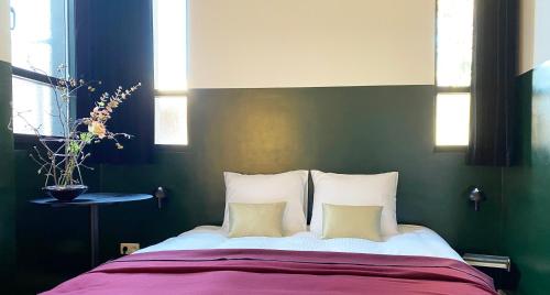 a bedroom with a large bed with two pillows at B&B Expo House in Antwerp