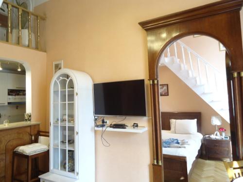 a bedroom with a bed and a desk with a television at Apartment Jafa in Tbilisi City