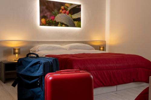 
a hotel room with two beds and two luggage bags at CasaTrapani Rooms & Apartments in Trapani
