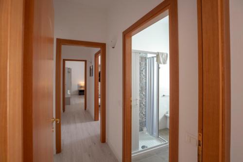 un corridoio con due porte e uno specchio di CasaTrapani Rooms & Apartments a Trapani