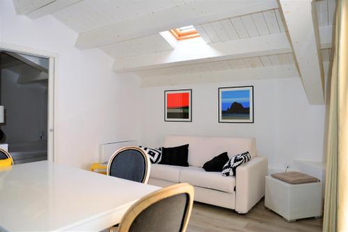 a living room with a white couch and a table at The Old Bakery in Cagliari