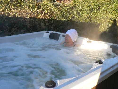 a woman in a bath tub with a towel on her head at Penzion U Lesa in České Budějovice