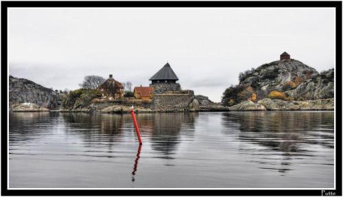 a small island in the middle of a body of water at Hotel Wassilioff - Unike Hoteller in Stavern