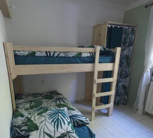 a bunk bed with a ladder in a room at Gite Aoura baronnies provençales in Montjay