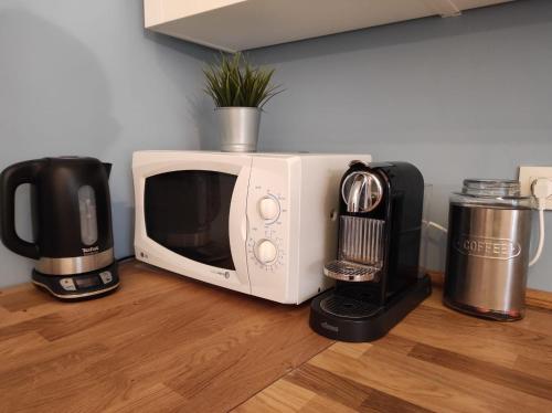 a microwave sitting on a counter next to a coffee maker at Ceci's home - Few steps from Monaco WITH PARKING in Beausoleil