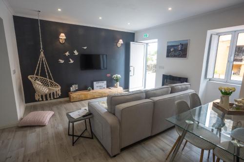 a living room with a couch and a table at Bicycle Villas - AL in Ponta Delgada