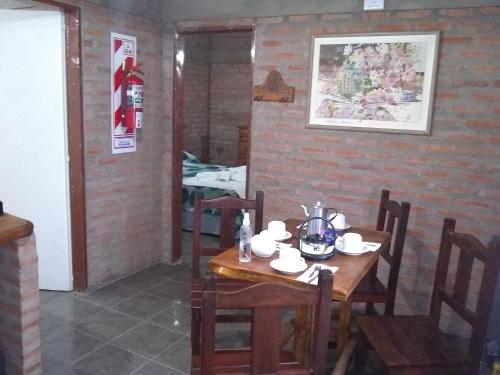 a dining room with a wooden table and chairs at La Galensa in Trevelin