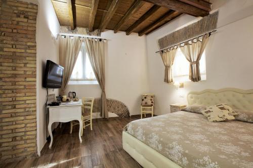 a bedroom with a bed and a desk and a television at Navona Sweet Home in Rome