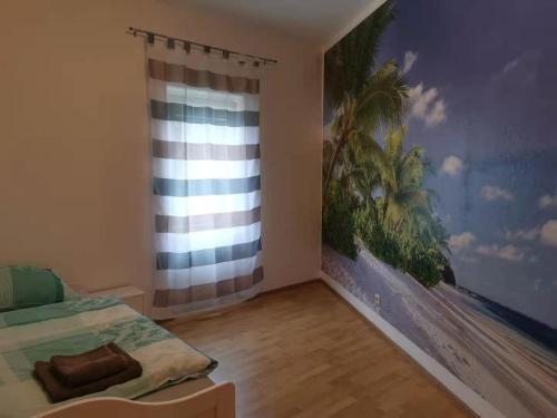 1 dormitorio con 1 cama y una pintura en la pared en Gute Laune, en Friedrichshafen