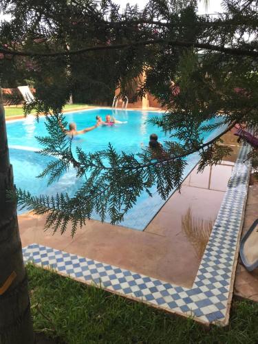 a group of people in a swimming pool at Les Jardins de Ryad Bahia in Meknès