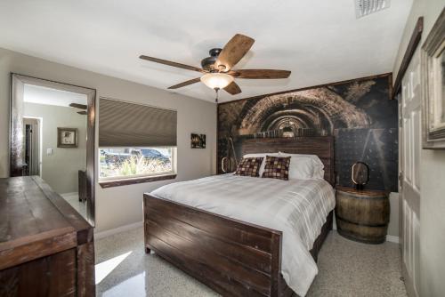 a bedroom with a bed and a ceiling fan at Gulfport Beach Vacation Rental in St. Petersburg