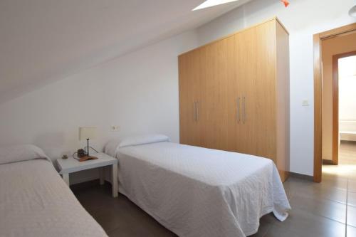 Postel nebo postele na pokoji v ubytování Apartamento en la Playa de Quenxe
