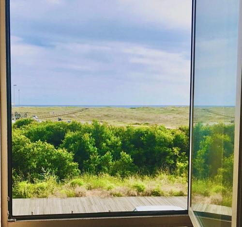 a window with a view of a field at Sea, Surf and Sun in Azurara