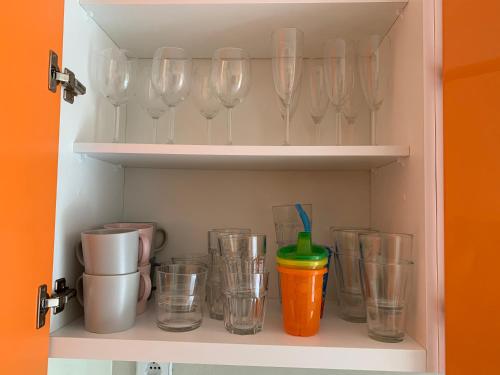 a cupboard filled with wine glasses and a bunch at Sea, Surf and Sun in Azurara