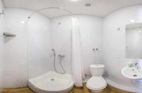 La salle de bains blanche est pourvue de toilettes et d'un lavabo. dans l'établissement Studio with City View - Hrekivska str. 5-1, à Kharkov