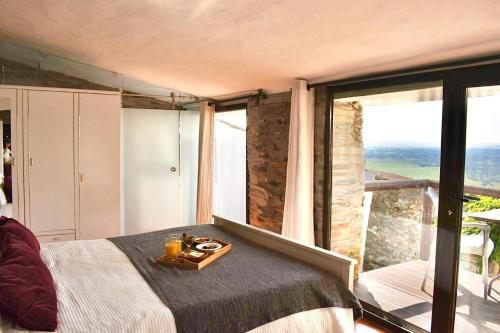 a bedroom with a bed with a tray of food on it at Casa D’ Santiago in Monsaraz