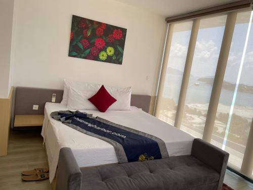 a bedroom with a bed and a large window at Harbor View Villa in Nha Trang