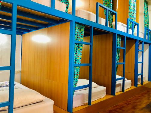 a bunk bed room with blue ladder bunk beds at DoDoWu Homestay in Lanyu