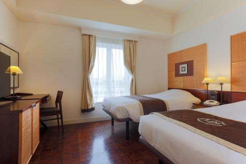 Ένα ή περισσότερα κρεβάτια σε δωμάτιο στο Hotel Monterey Ginza