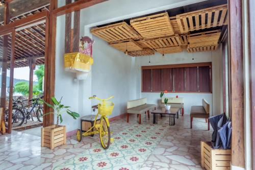 a bike parked in a room with a table and chairs at The Joglo Beratan in Bedugul