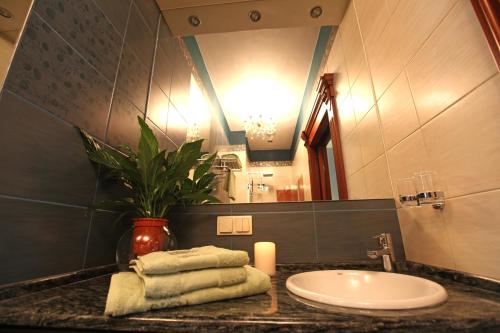 a bathroom with a sink and a candle on a counter at Apartamenty Klejnot Sopotu in Sopot