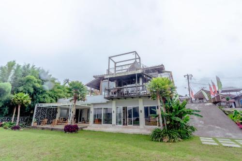 a house with a balcony on top of it at The Joglo Beratan in Bedugul