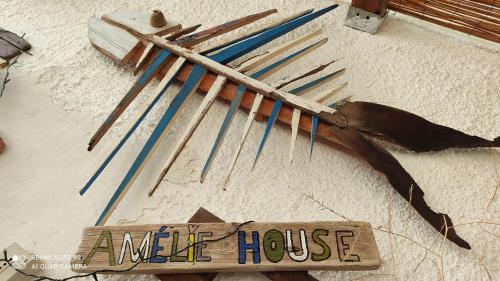 a group of sticks and a write house sign on the floor at Amélie House in Marsala
