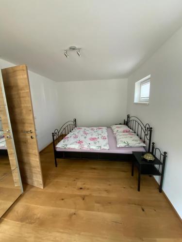 a bedroom with a bed in the corner of a room at Apartments Traun-haft in Bad Aussee