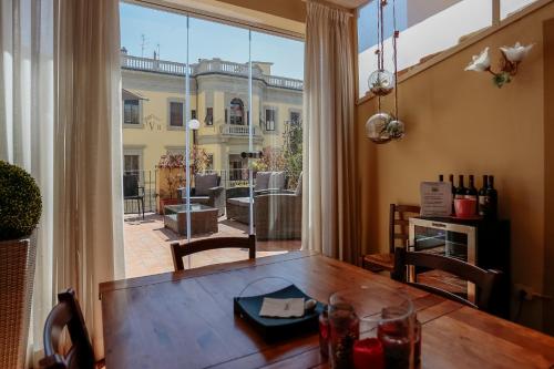 a dining room with a table and a large window at Il Valentino Luxury Houses in Florence
