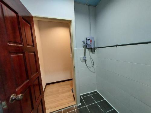 a bathroom with a door and a shower stall at Ren-Hana Kundasang in Kundasang