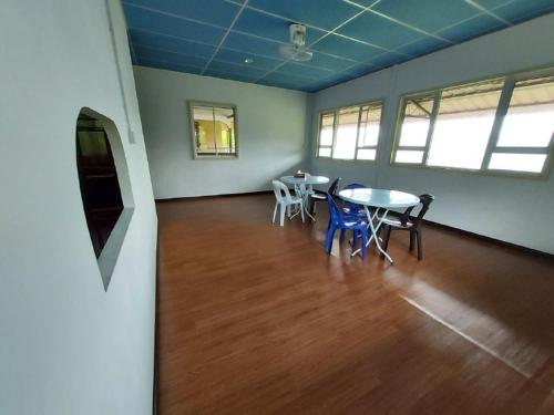 an empty room with a table and chairs in it at Ren-Hana Kundasang in Kundasang
