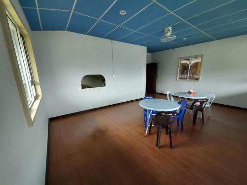 a room with two tables and chairs in a room at Ren-Hana Kundasang in Kundasang
