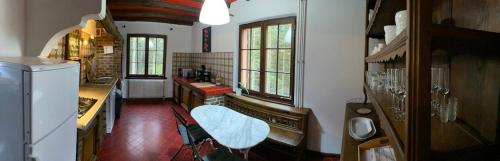 a kitchen with a sink and a refrigerator in it at CHALET DE MANU in Sondernach