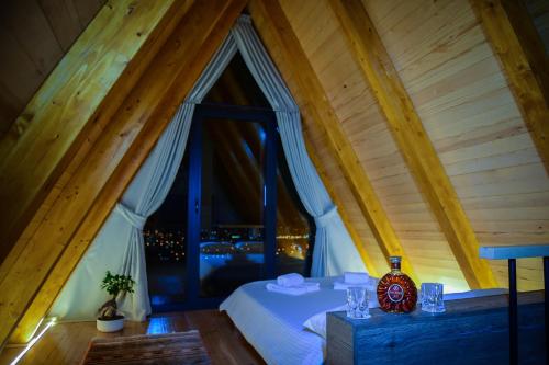 a bedroom with a bed with a large window at Masarotto Luxury Chalet #1 in Belgrade