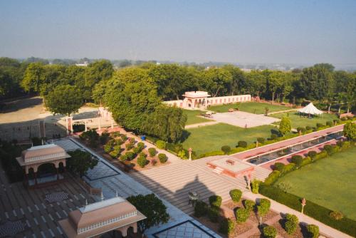 an aerial view of a park with a building at Umaid Palace - A Lakeside Resort - 25 minutes from Mehandipur Balaji - 20 minutes from Chand Baori Stepwell Abhaneri & 40 minutes from Bhangarh Fort in Dubbī