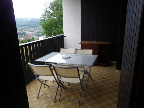 a white table and two chairs on a balcony at f2 gerardmer in Gérardmer